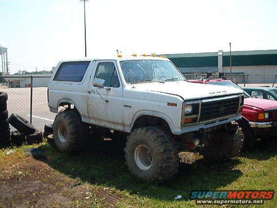 White lifted Ford Bronco with large tires, 3/4 front view