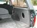 1994 Ford Bronco - The interior cargo area of a 1994 Ford Bronco shows a speaker cutout on the side panel.