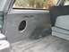 1994 Ford Bronco - Vehicle's rear interior cargo area with a custom speaker cutout in the paneling.