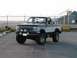 1994 Ford Bronco - This lifted 1994 Ford Bronco features a two-tone paint scheme and aftermarket accessories, including a bull bar and auxiliary lights.
