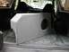 1994 Ford Bronco - A custom-built subwoofer box is installed in the cargo area of an SUV, obscuring the rear seating.
