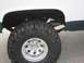 1992 Ford Crown Victoria - Rear wheel and suspension detail of a lifted truck with off-road tires.