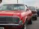 1992 Ford Crown Victoria - A classic red convertible is parked next to a black sedan, with a partial license plate visible.