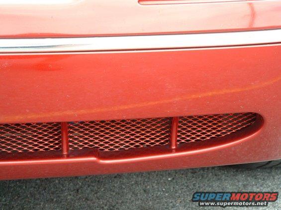 Red 1999 Ford Crown Victoria front grille with chrome trim above