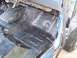 1990 Ford Bronco - The interior floor of a 1990 Ford Bronco shows black undercoating and exposed metal.