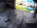 1990 Ford Bronco - Vehicle interior floor with undercoating applied, brake pedal visible.