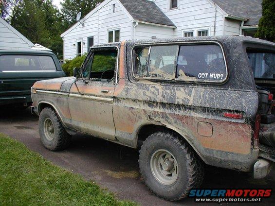Mud-covered Ford Bronco parked next to another vehicle