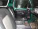 1979 Ford Bronco - The interior of a 1979 Ford Bronco shows black seats and a green exterior.