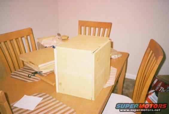 Wooden box and stacked wood on a table with chairs