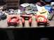1985 Ford Bronco - Various red tow shackles and hardware are laid out on a cluttered workbench.