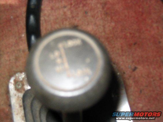 Gear shifter knob with visible gear pattern and text