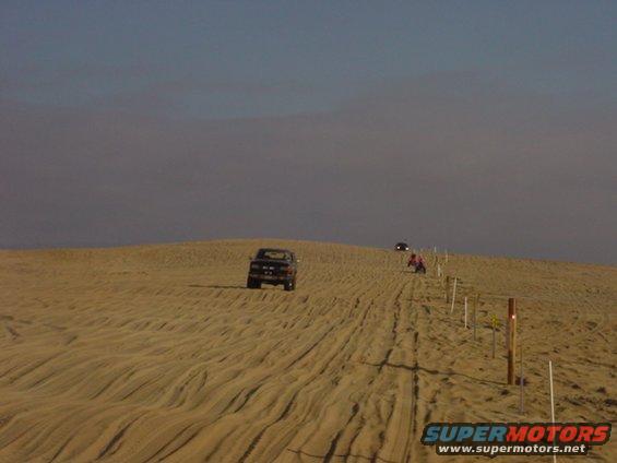 dsc00018.jpg Chris driving my bronco and hitting the whoops,  the soft cepek coils did alright.