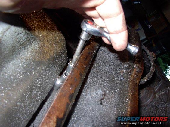 img_0582.jpg These two middle rear bolts are a real treat to get to.  Ford engineers should get a sound beating for sticking them under the trans mount crossmember. A 1/4" universal joint really helped out here.