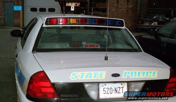 White police car rear with STATE POLICE text and license plate 520-NZT