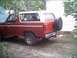 1985 Ford Bronco - This 1985 Ford Bronco is seen from the rear quarter angle, a red body with a white top and a spare tire mounted on the tailgate.