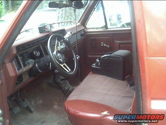 Interior of 1985 Ford Bronco showing dashboard, steering wheel, and seats