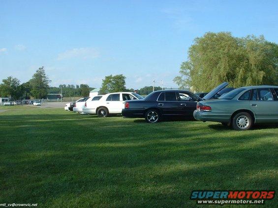 Dark sedan parked on grass, 2004 Ford Crown Victoria