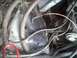 1985 Ford Bronco - Close-up view of a cluttered engine bay with various hoses and wiring harnesses.
