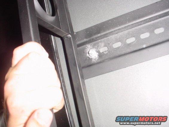 dsc00002.jpg Drilled through the hard part of the top, the front  bolts go down through the cab also, so the top will kind act as a brace.