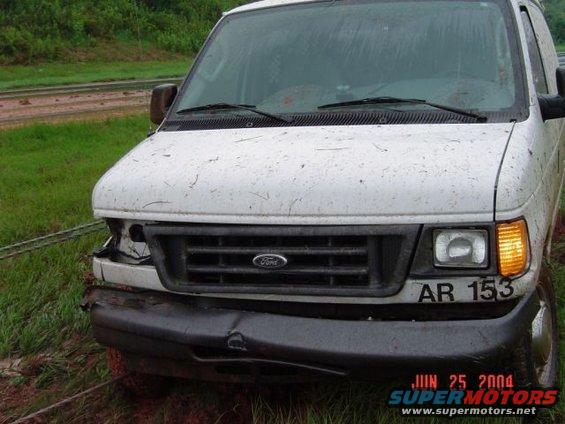 White Ford van with a dented bumper and damaged headlight, seen from the front