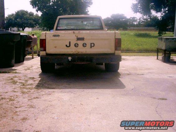 Cream Jeep pickup truck rear view with 'JEEP' badging