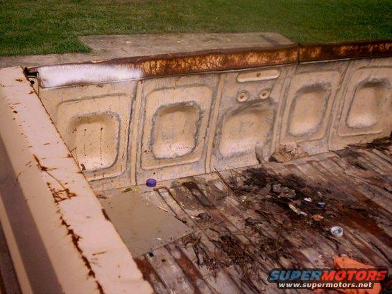 Rusty truck bed interior with ribbed floor and recessed panels