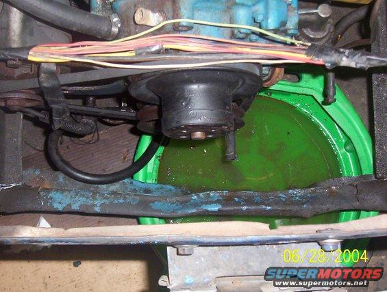 Car engine water pump with green coolant in a green pan below. Date stamp reads 06/28/2004