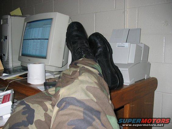 Feet up on desk with computer and printer