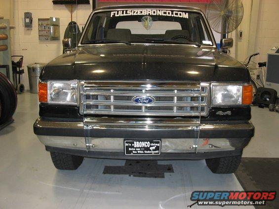 Black Ford Bronco front view. Has a 'FULLSIZEBRONCO.COM' sticker on the windshield and a 'It's a BRONCO thing' plate on the bumper