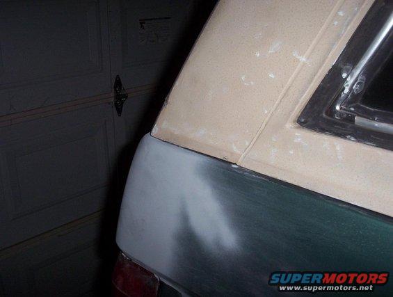 Vehicle rear quarter panel and roofline with primer and body filler