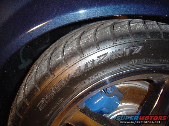 Close-up of a tire with 255/40ZR17 markings and a blue brake caliper