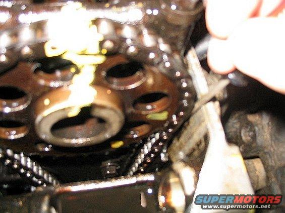 Close-up of engine timing chain and gears with yellow grease
