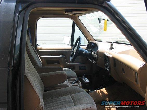1988 Ford Bronco interior showing front seats, dashboard, steering wheel, and center console