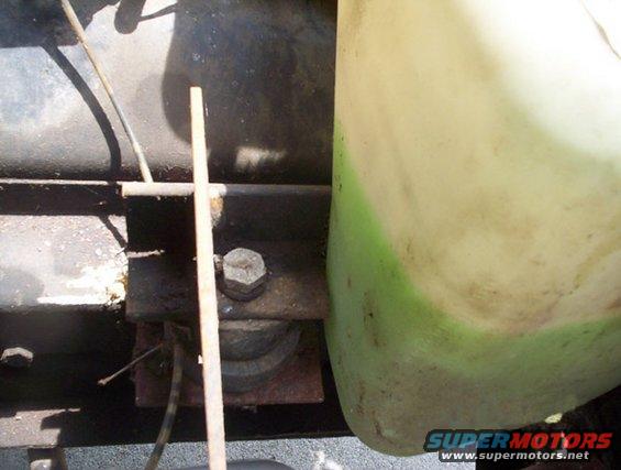Close-up of a light-colored fluid reservoir with green markings