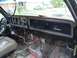 1981 Ford Bronco - The interior dashboard shows extensive exposed wiring and a "Custom" badge on the glove compartment.
