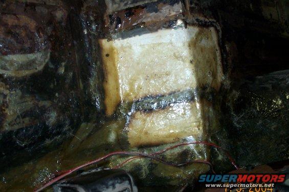 floor-012.jpg Drivers side after patches welded in and covered with fiberglass and resin.