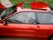 1996 Ford Probe - Side view of a red 1996 Ford Probe coupe, showing its sunroof and interior details.