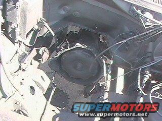 Engine bay with transmission and Supermotors.net watermark