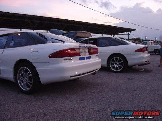 Two white Ford Probe cars parked side-by-side, rear view