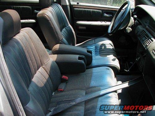Interior view of a car with cloth and leather seats, dashboard, and steering wheel
