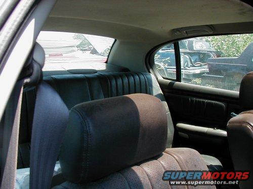 Interior shot of a car looking out at other vehicles in a junkyard