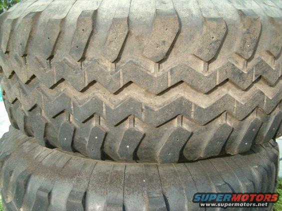 Close-up of a large, knobby tire tread with visible studs