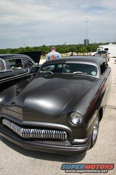 Dark gray custom sedan front view with chrome grille