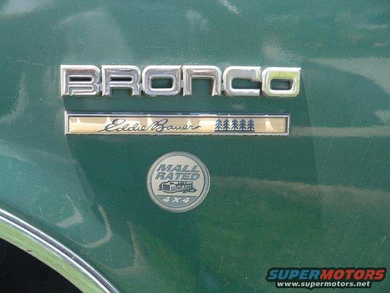 Chrome Bronco and Eddie Bauer badges plus a Mall Rated 4x4 emblem on green sheet metal
