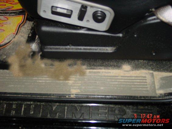 Interior door sill with "HUMMER" text and dust