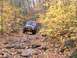 1980 Ford F-100 - Off-roading through colorful autumn foliage on a challenging rocky path.