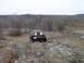 1980 Ford F-100 - A black Jeep Wrangler navigates a rocky, wooded landscape under an overcast sky.