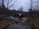 1980 Ford F-100 - Off-road vehicle navigates a rocky stream crossing on a wooded trail.