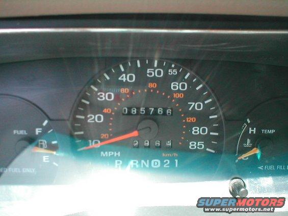 Car dashboard with speedometer, odometer showing 85766, fuel gauge, and temperature gauge