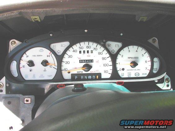 car's instrument cluster with speedometer, tachometer, fuel gauge, and temp gauge visible